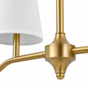 Brass finish detail with white fabric shade and branch arm