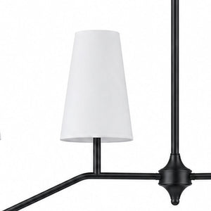 Black finish detail near white fabric shade and branch arm
